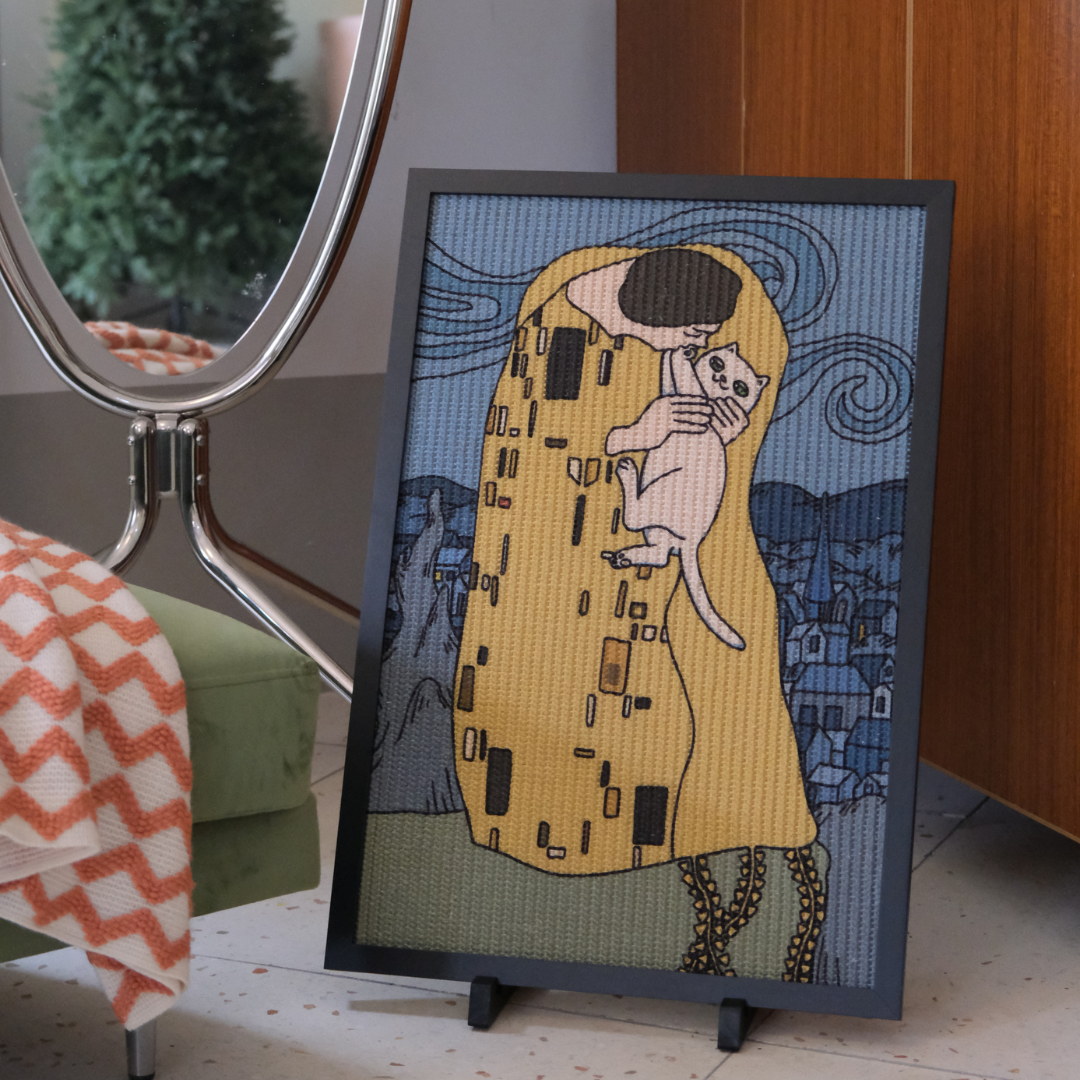 Da Kiss Cat Scratcher Standalone, on the ground by a mirror and sofa